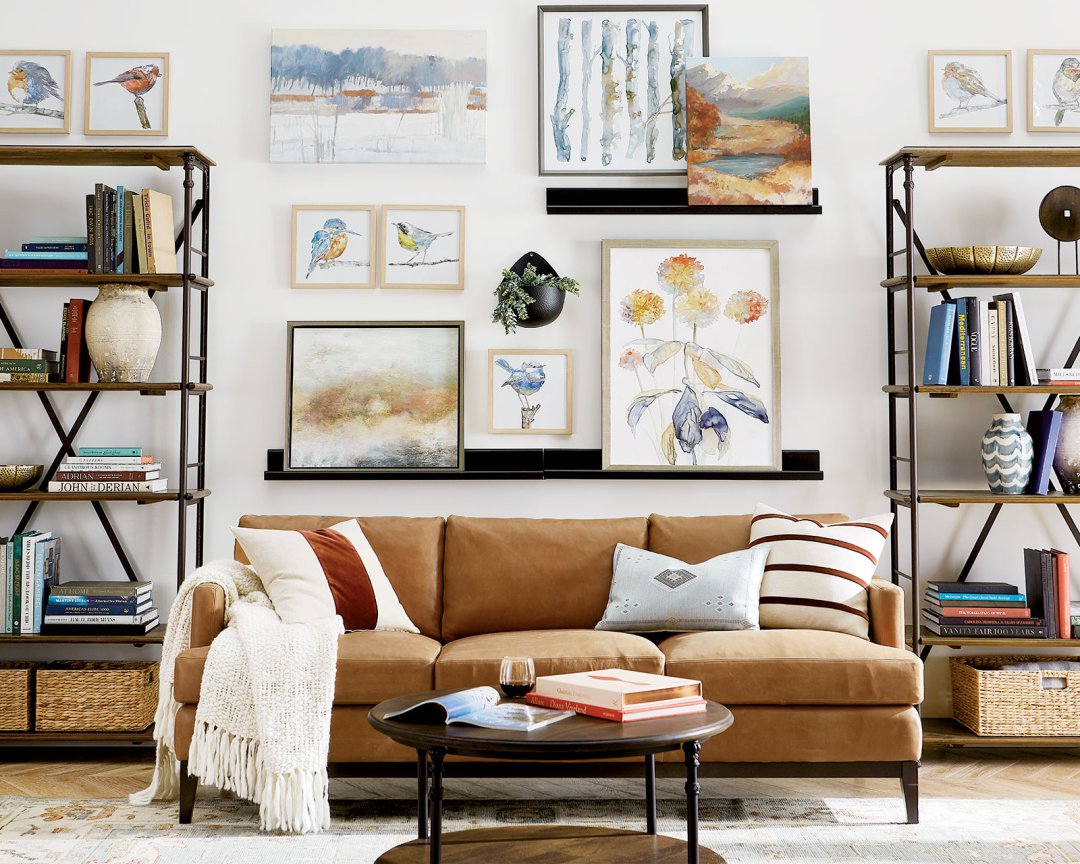 Living room with a brown sofa, coffee table, and wall art